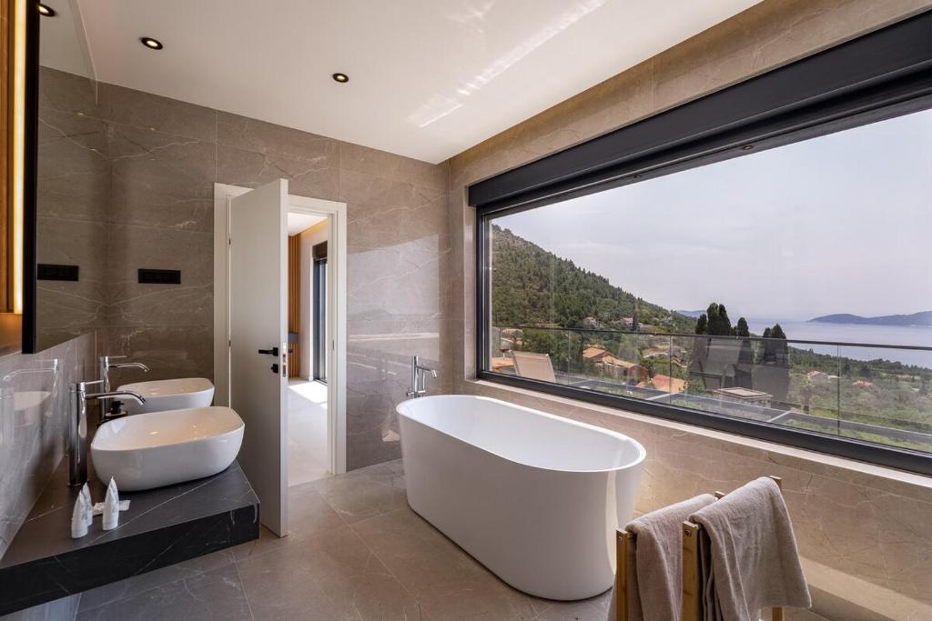 Marble bathroom with freestanding tub and sea view